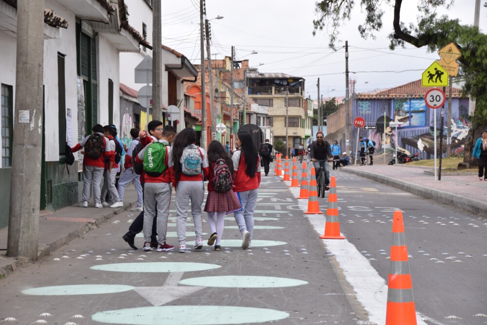 A group of teenagers walking down the street in Bogota