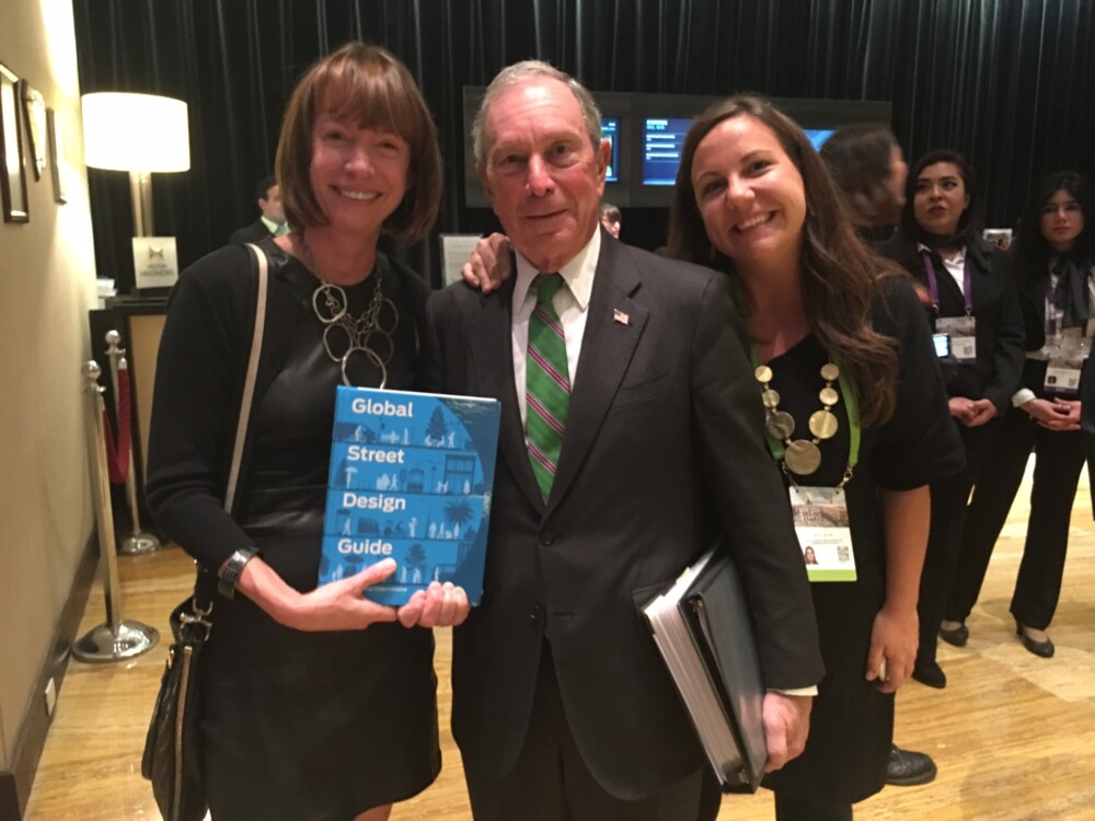 Picture of Janette Sadik-Khan, Mike Bloomberg, and Skye Duncan holding the Global Streets Design Guide